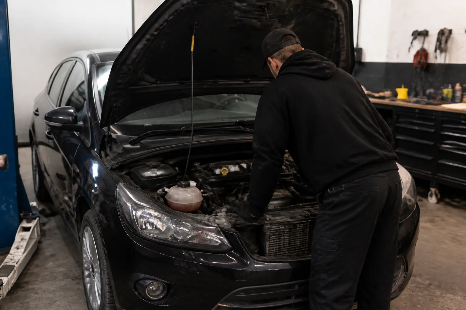 Mechanic inspecting the cooling system of a car in an independent UK garage